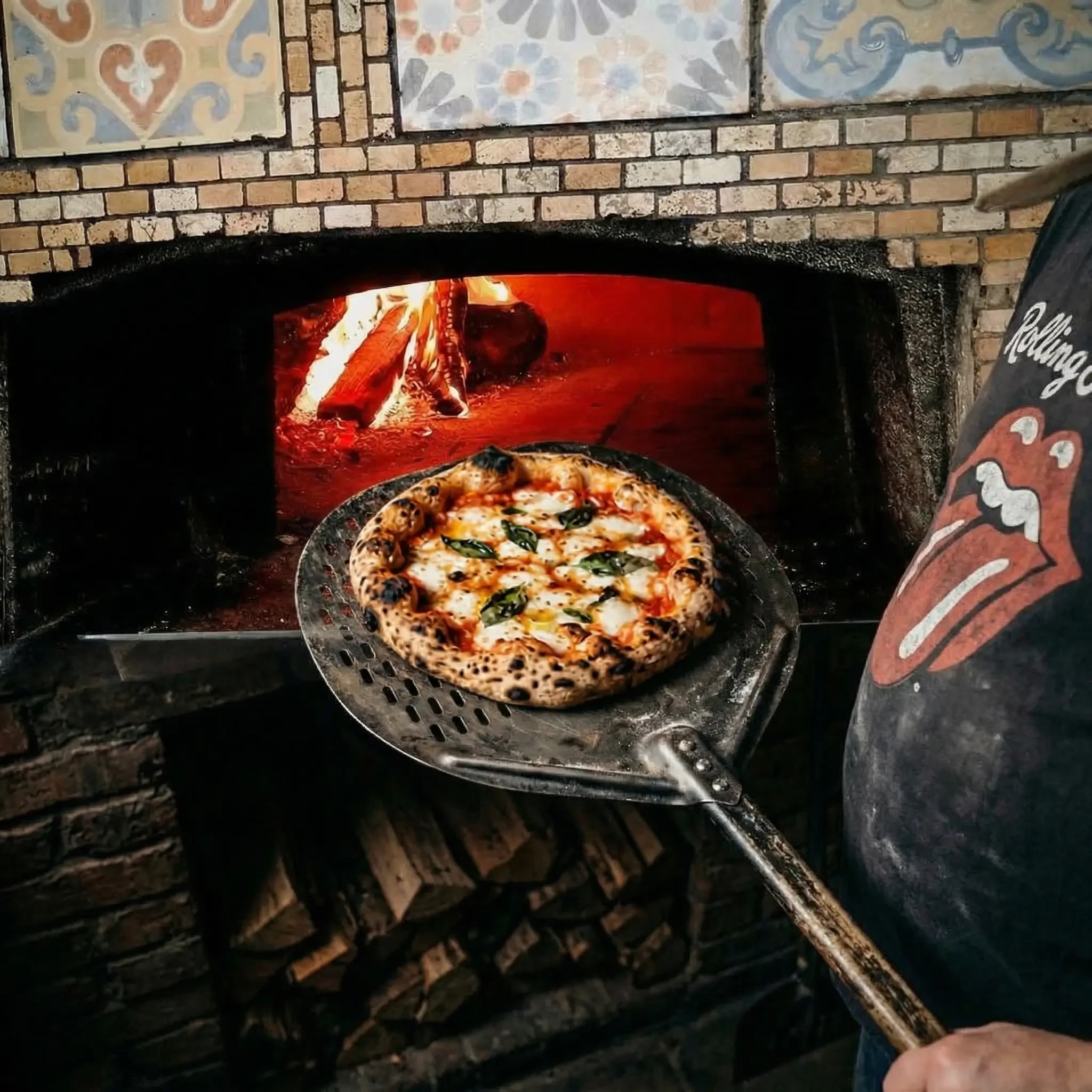 Wood-fired pizza oven with flames